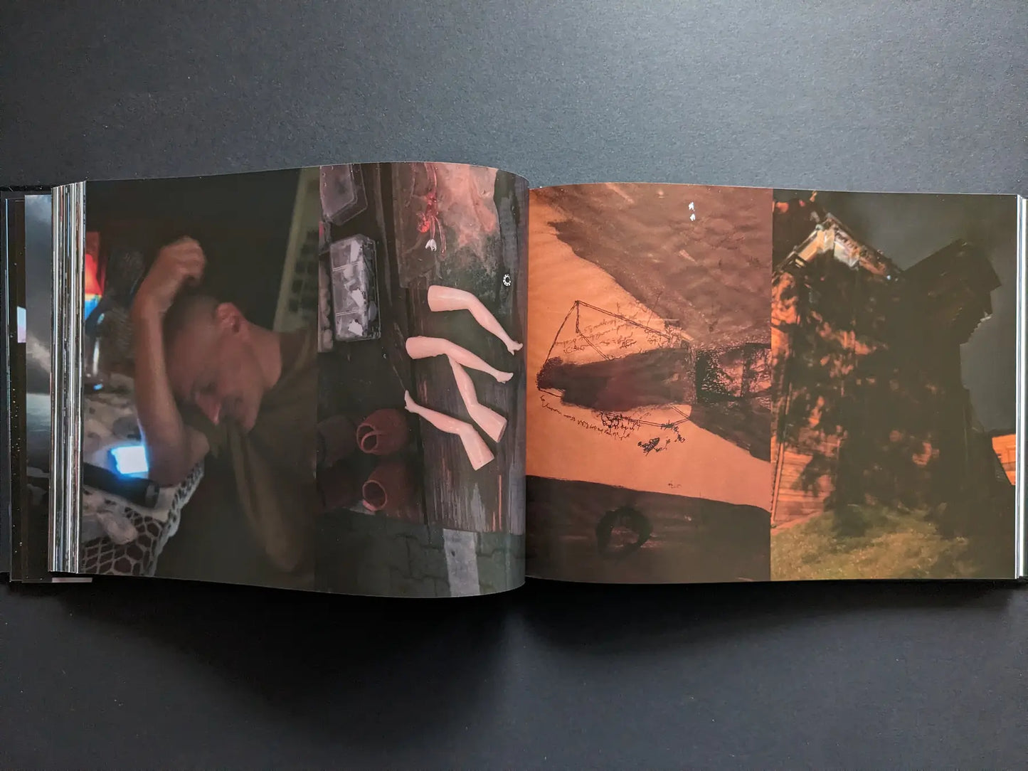 A man holding his head, prosthetic limbs on a table, a handwritten diagram and a house at night, from the photobook Keep Distance by Boris Mikhailov.