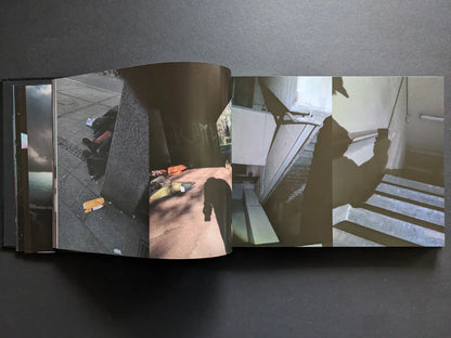 Interior spread from Keep Distance with colour photographs of people sleeping rough in the city, an underpass, and a silhouetted figure on stairs.