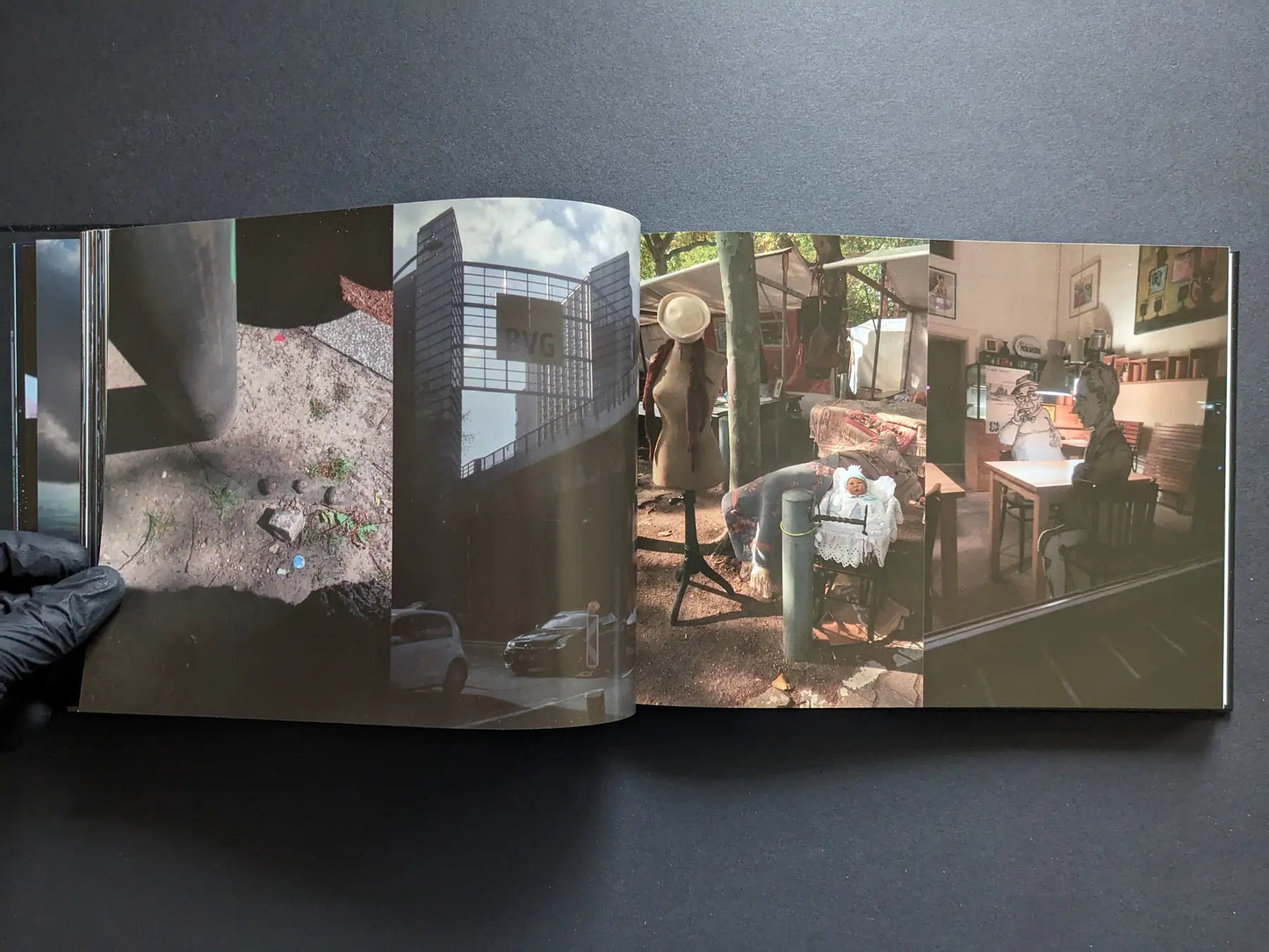 Interior spread with ground details, a glass office building, a mannequin and pram, and a seated figure indoors.