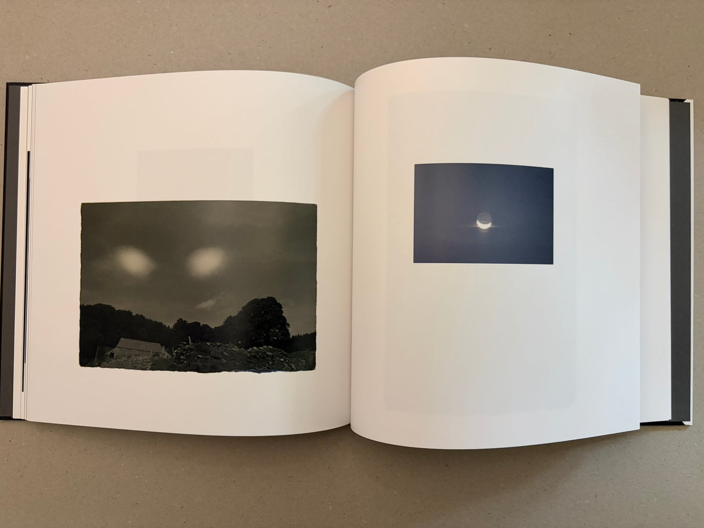 Open Kurayami spread with a dark landscape image on the left and a small moon photograph on the right.