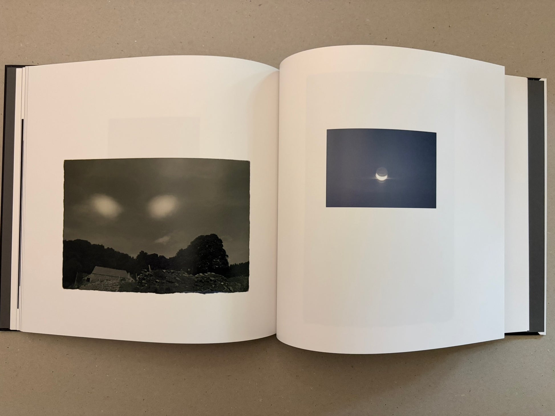 Open Kurayami spread with a dark landscape image on the left and a small moon photograph on the right.