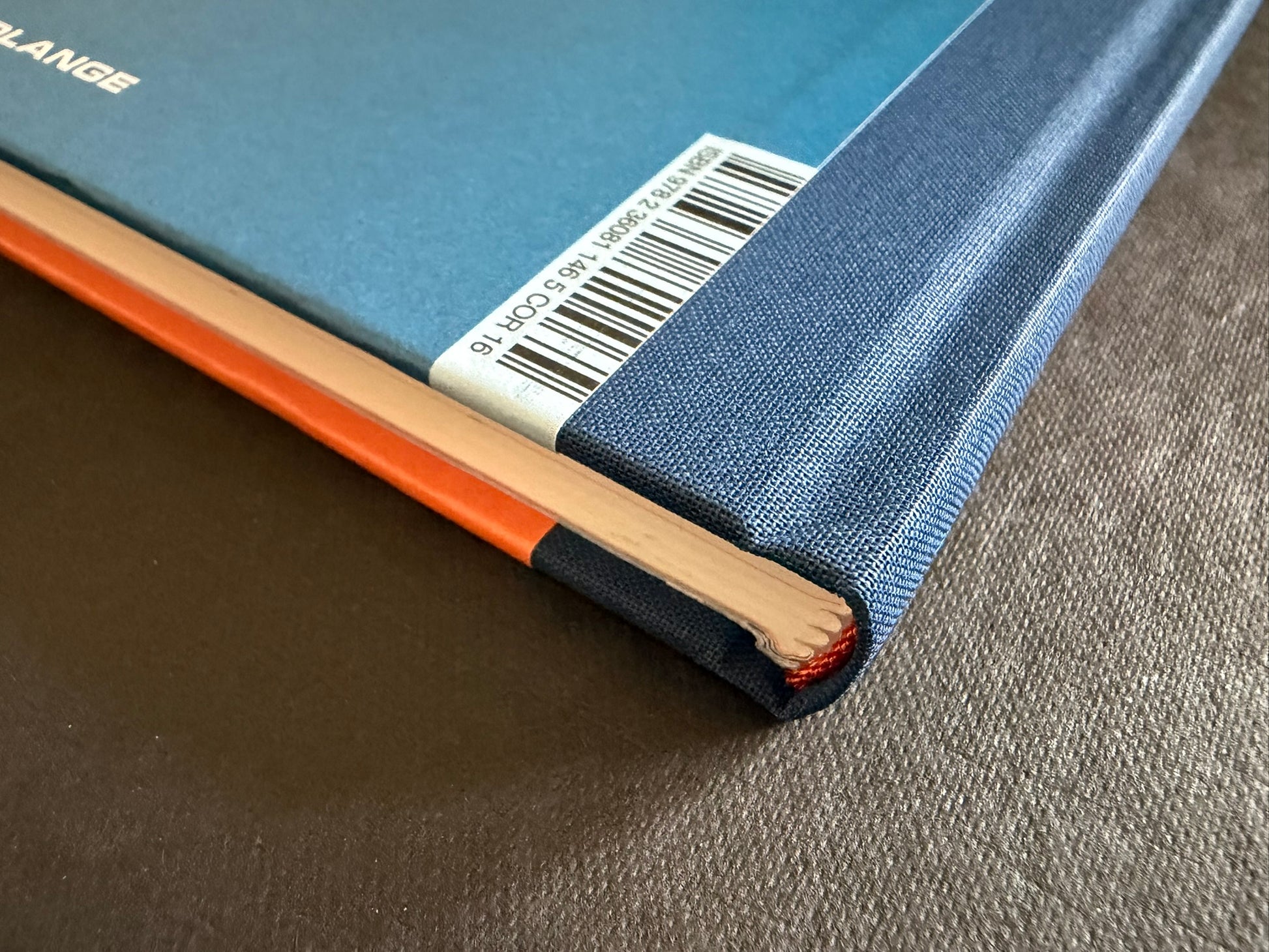 Close-up of the blue cloth spine and barcode on À l'intérieur des yokai by Shigeru Mizuki.