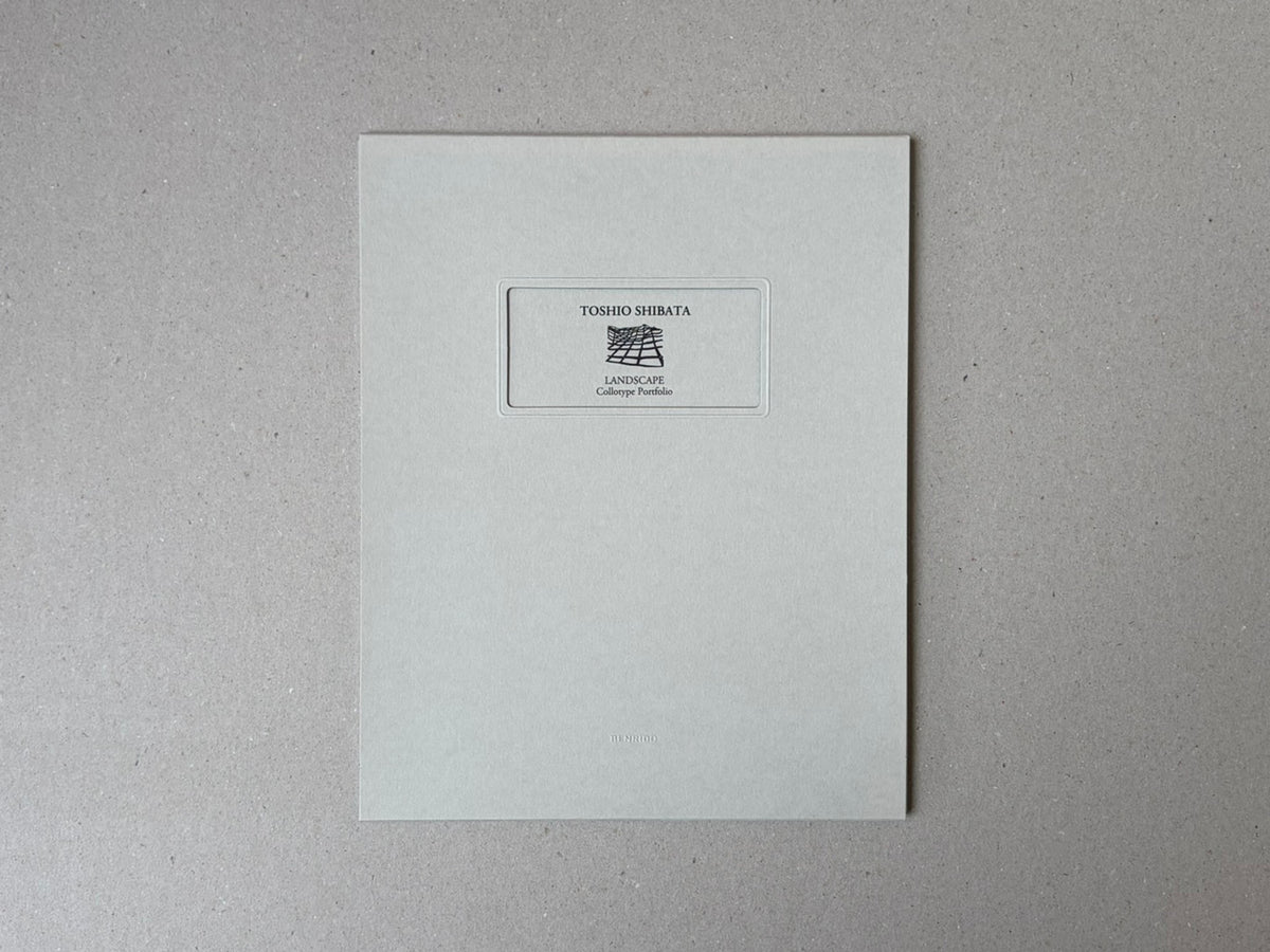 Front cover of Toshio Shibata, Landscape Collotype Portfolio, with a small central label on a pale grey cover.