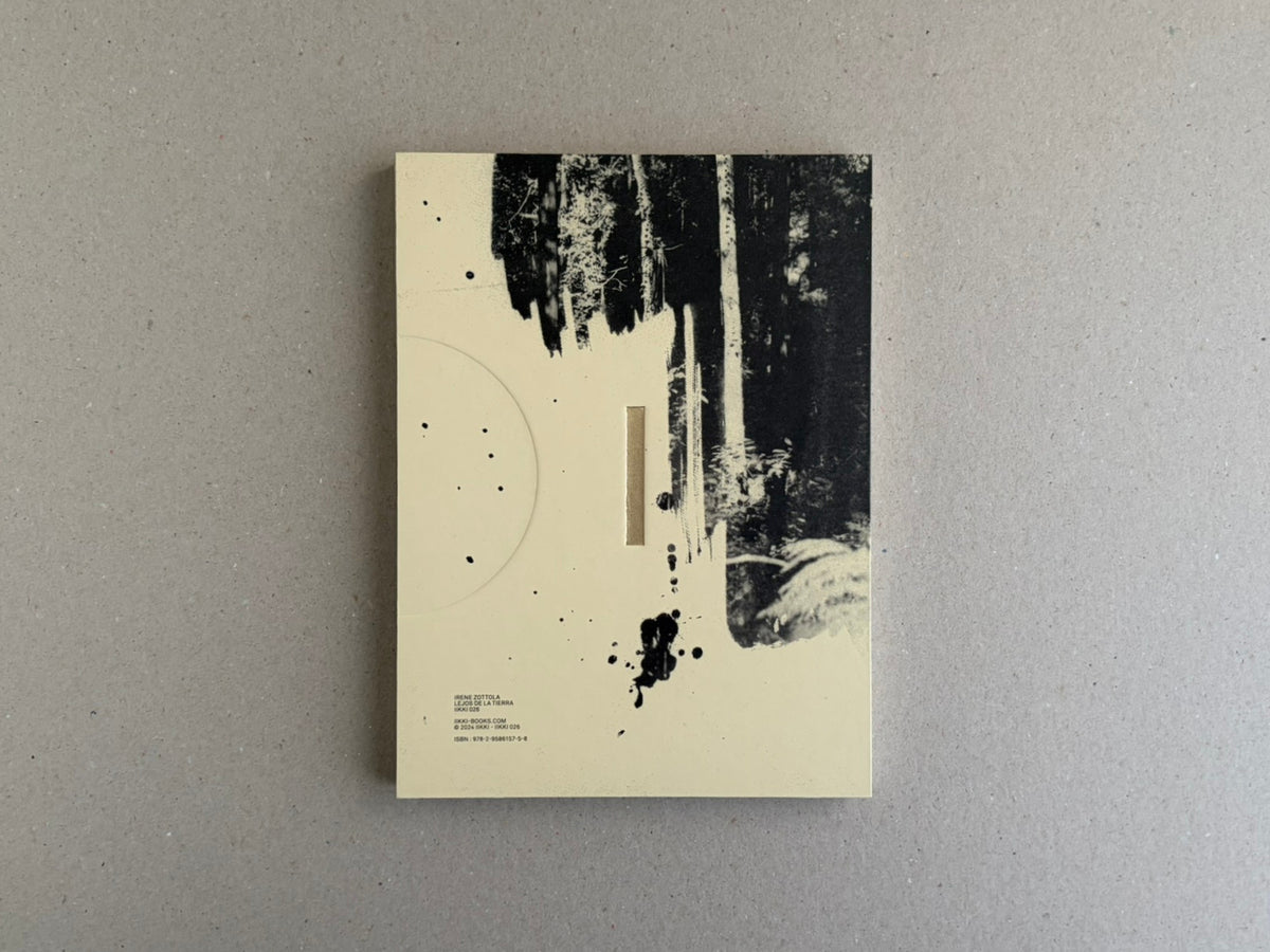 Lejos De La Tierra – Irene Zottola, cover with a cream background and black forest-like image, shown on a grey surface.