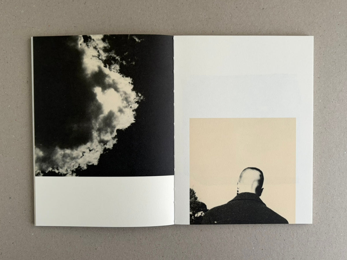 Open photobook spread from Lejos De La Tierra – Irene Zottola, showing a black-and-white cloud image on the left page and a portrait seen from behind on the right page.