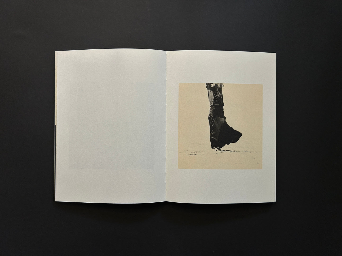 Open spread from Lejos De La Tierra showing a small black-and-white figure photograph on the right page