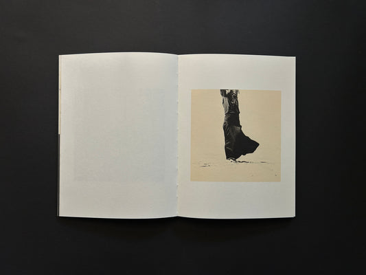 Open spread from Lejos De La Tierra showing a small black-and-white figure photograph on the right page