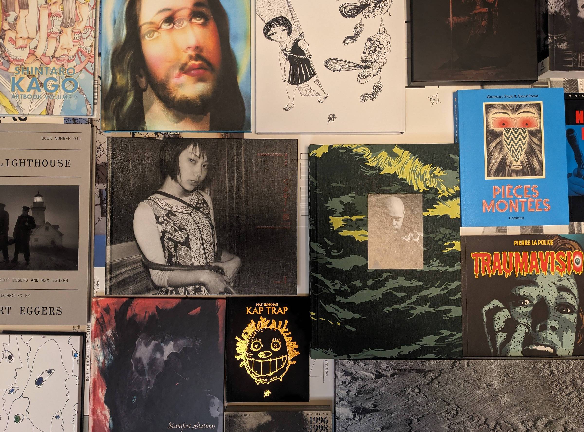 Selection of photobooks, artist books and experimental comics from independent Japanese and European presses laid out on a table at Lokator100