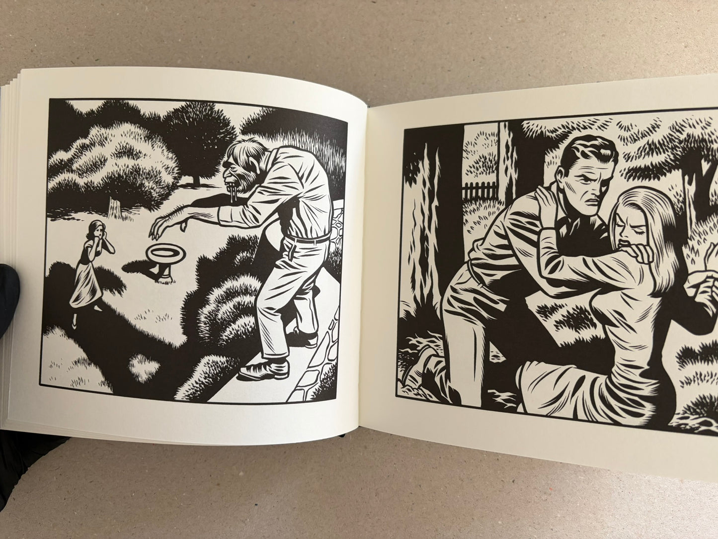 Black-and-white spread from Love Nest by Charles Burns with a woman’s portrait and a man at a machine, seen beside a large open book.
