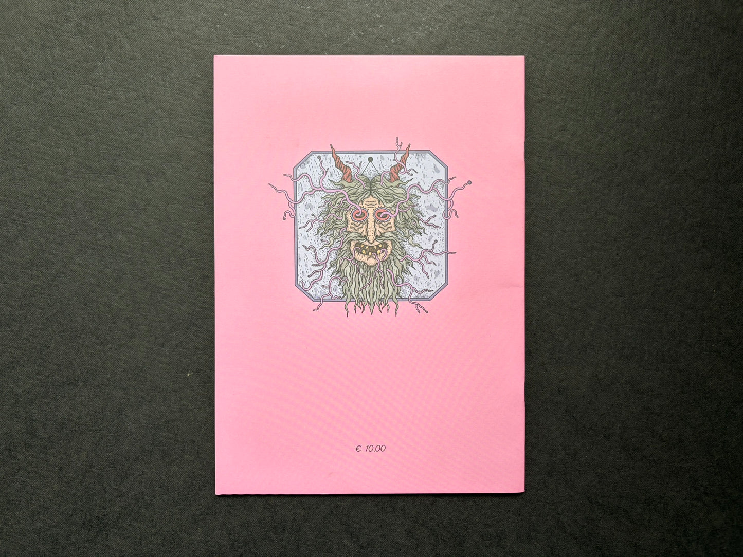 Mana by Dina Omut, back cover with pink background and central face illustration