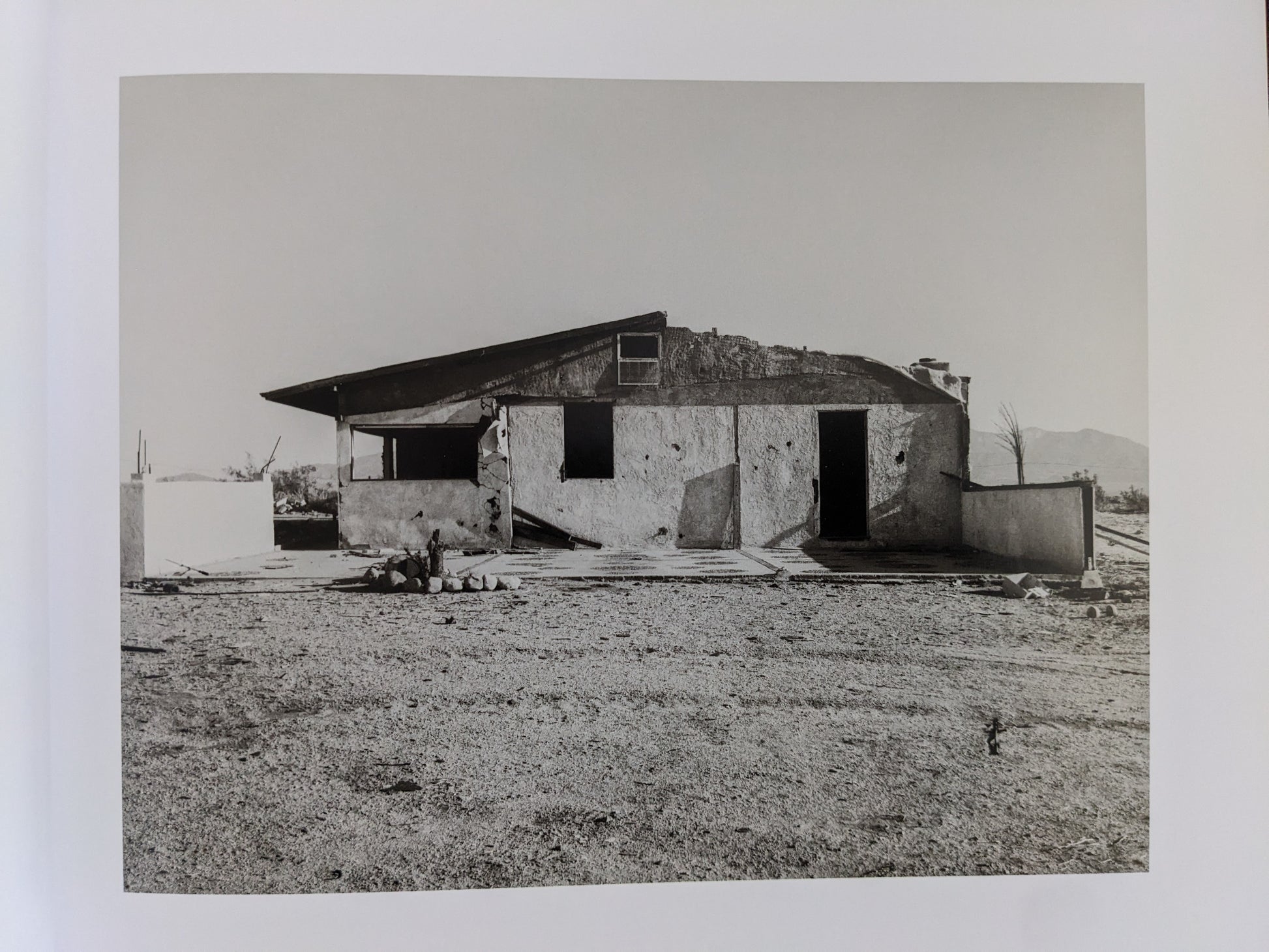 Ruined desert house with broken windows from Mark Ruwedel's "Message from the Exterior"