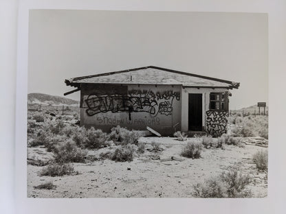 Desert house covered in graffiti photographed by Mark Ruwedel