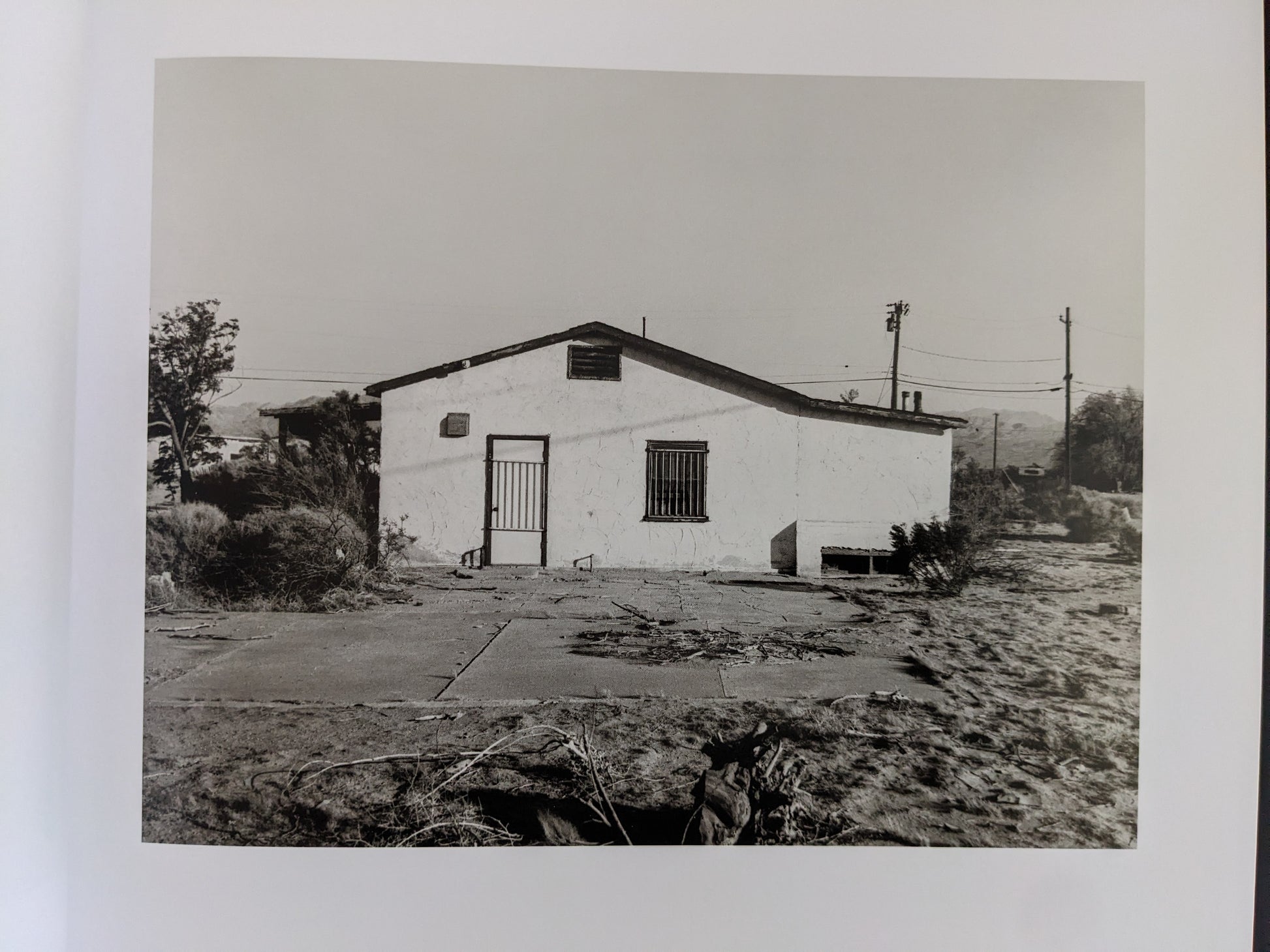 Back view of a deteriorating building in a desert landscape