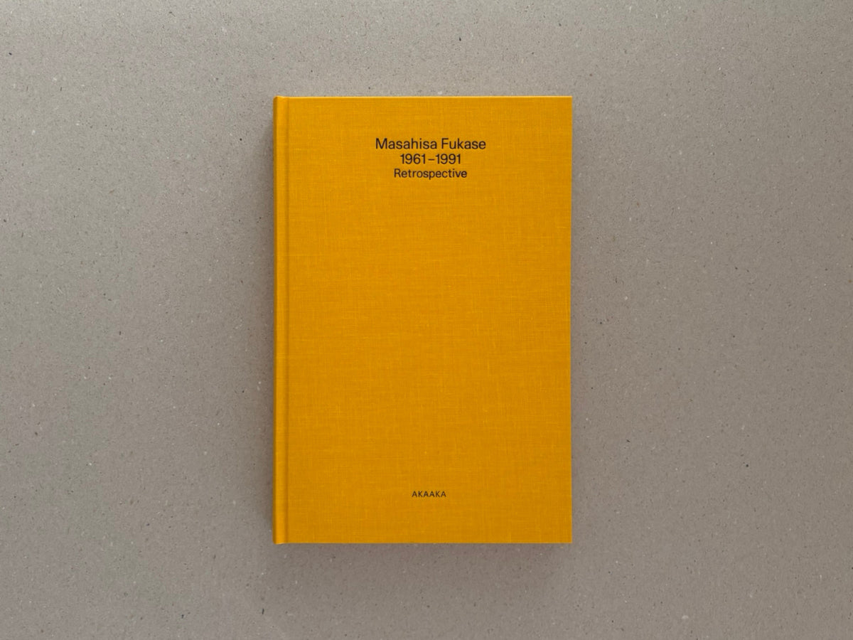 Masahisa Fukase 1961–1991 Retrospective, front cover of the yellow cloth hardcover with title on the upper half and AKAAKA at the bottom.