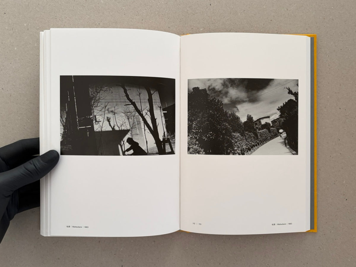Open spread from Masahisa Fukase 1961–1991 Retrospective showing two black-and-white photographs on facing pages, with page numbers 112–113 visible.