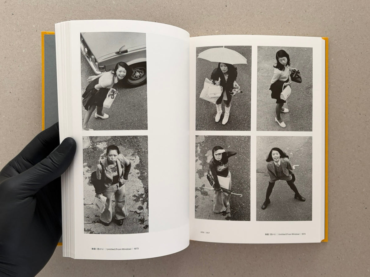 Open spread of Masahisa Fukase 1961–1991 Retrospective showing six black-and-white photographs of a woman viewed from above, with page numbers 056–057 visible.