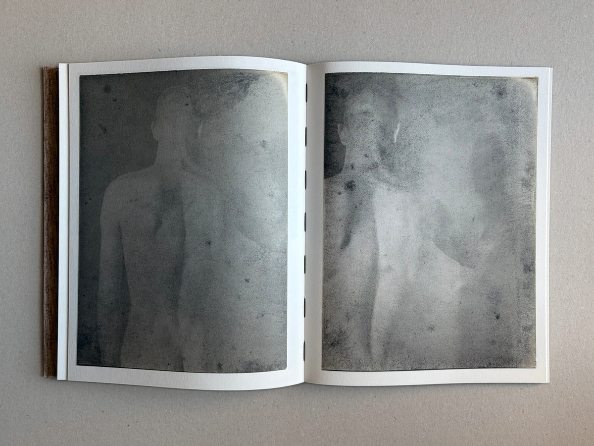 Open spread from Materia by Vic Bakin, showing two faded monochrome images on facing pages.