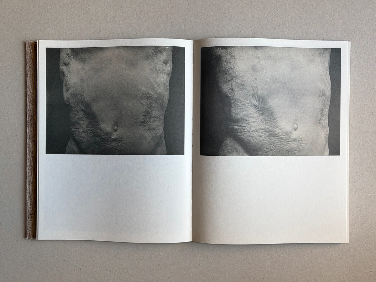 Materia by Vic Bakin, open photobook showing a two-page spread with grayscale torso photographs.