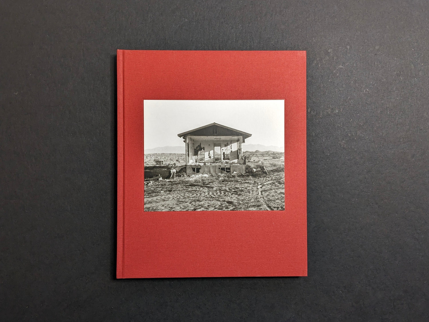 Cover of Message from the Exterior by Mark Ruwedel, with a tipped-in black-and-white image on red cloth