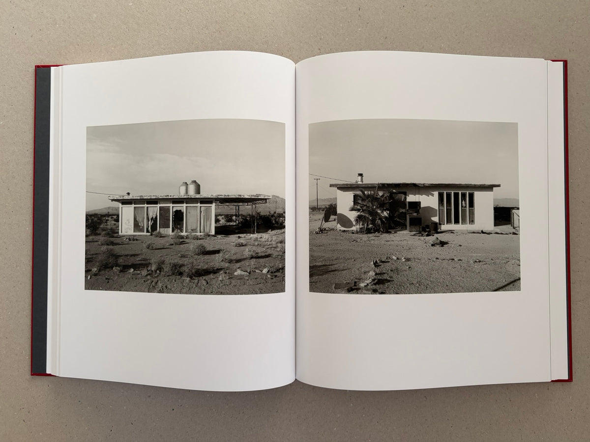 Open spread of Message from the Exterior by Mark Ruwedel, showing two black-and-white photographs of small desert houses.
