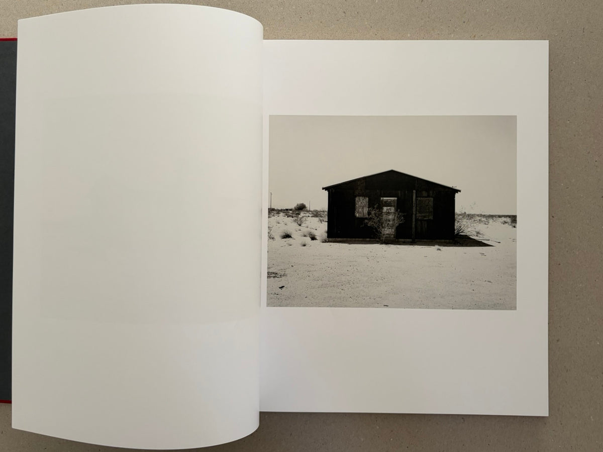 Open spread from Message from the Exterior by Mark Ruwedel, showing a desert house photograph on the right-hand page.