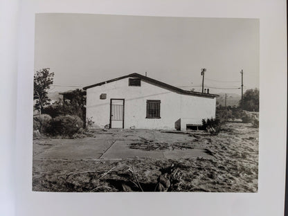 Rear view of a deteriorating building in a desert landscape