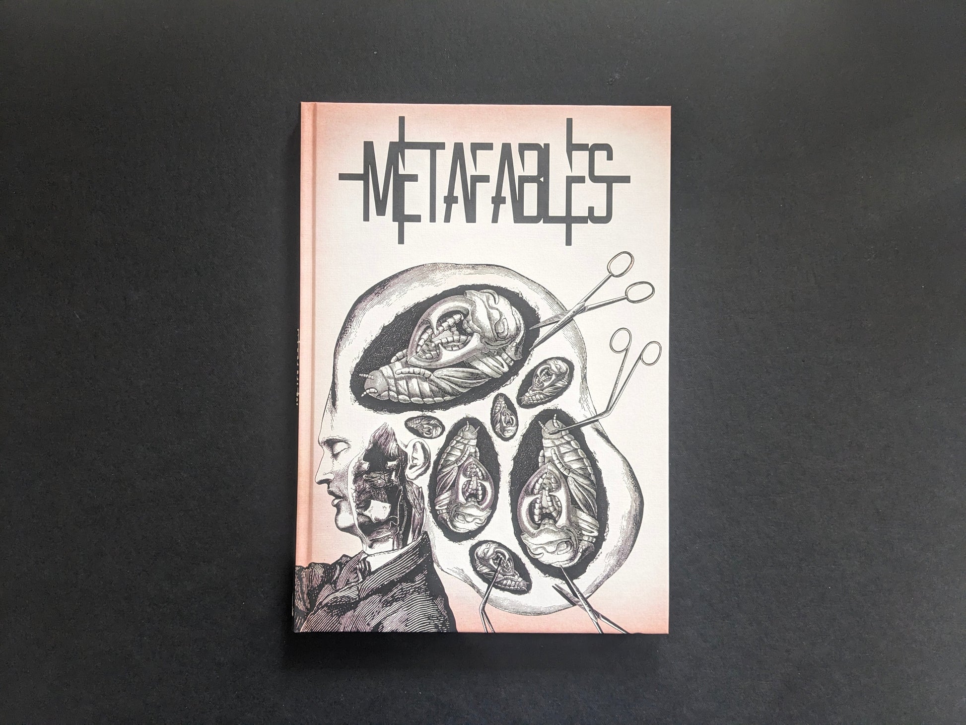 Front cover of METAFABLES, showing Andrew Blucha’s hardcover art book with an anatomical collage.