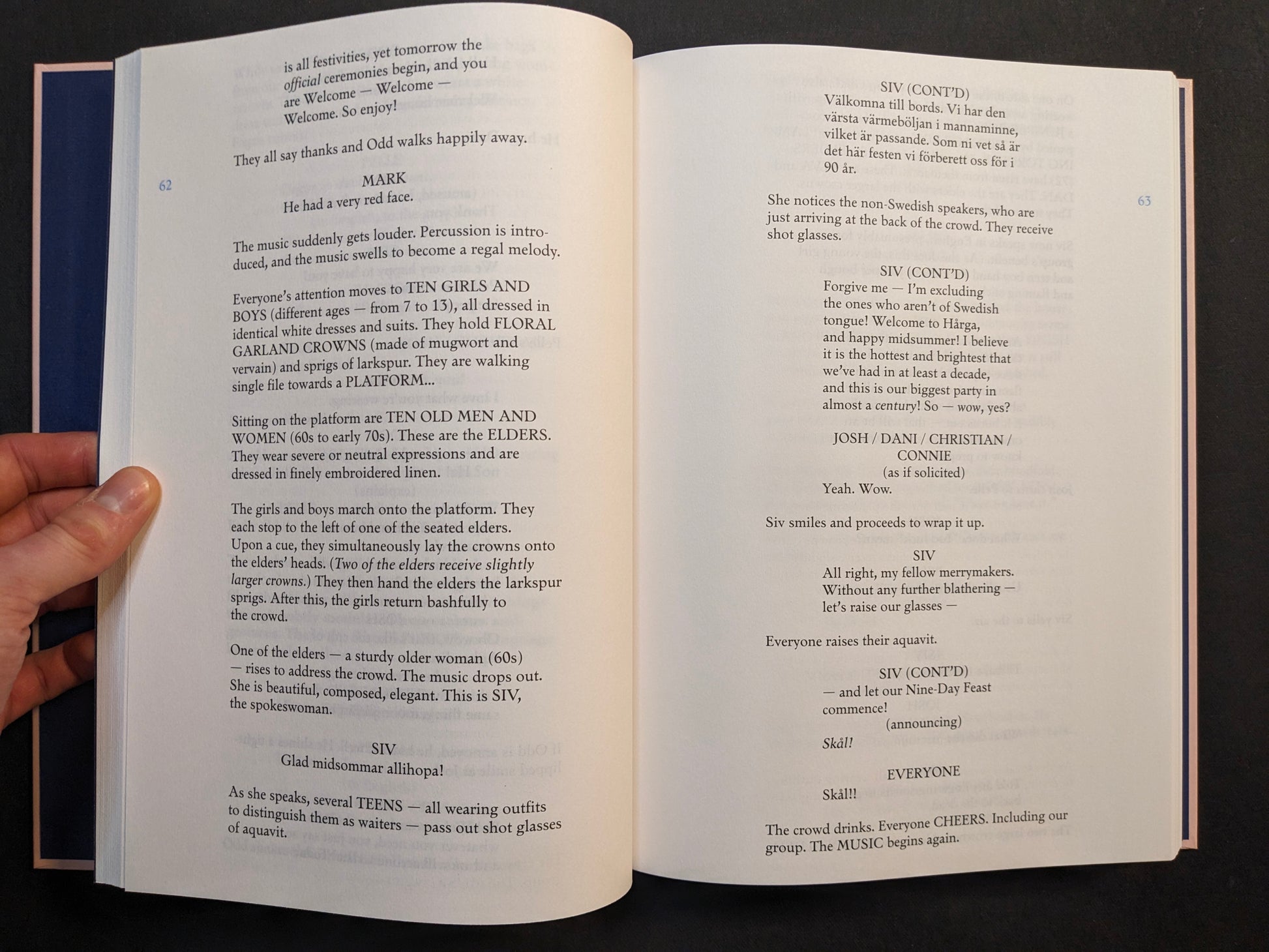 Interior spread from the Midsommar screenplay book featuring dialogue and scene text from the festival sequence.