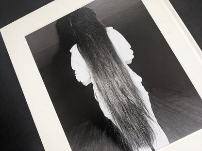 Black-and-white photograph from Mimi Plumb’s Landfall showing a reclining figure with long hair.
