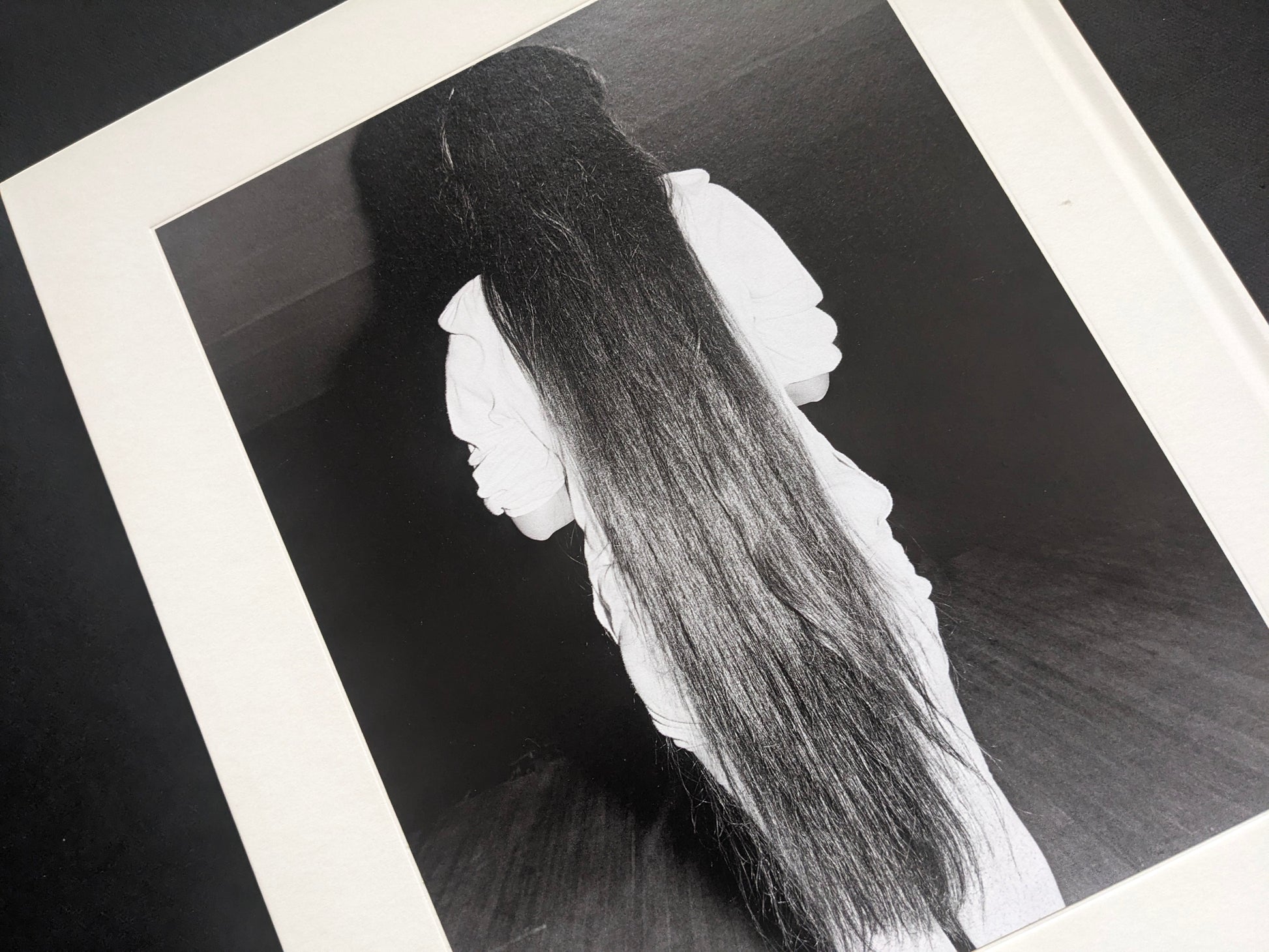 Black-and-white photograph from Mimi Plumb’s Landfall showing a reclining figure with long hair.