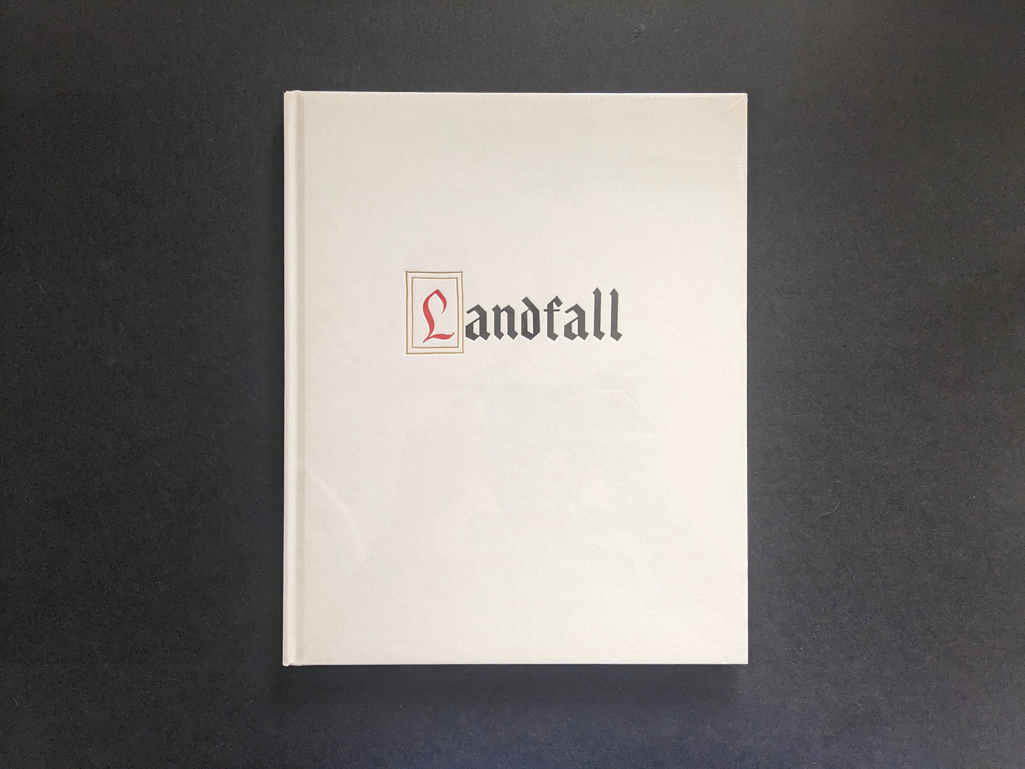 Front cover of Mimi Plumb’s Landfall photobook, white cover with vertical title.