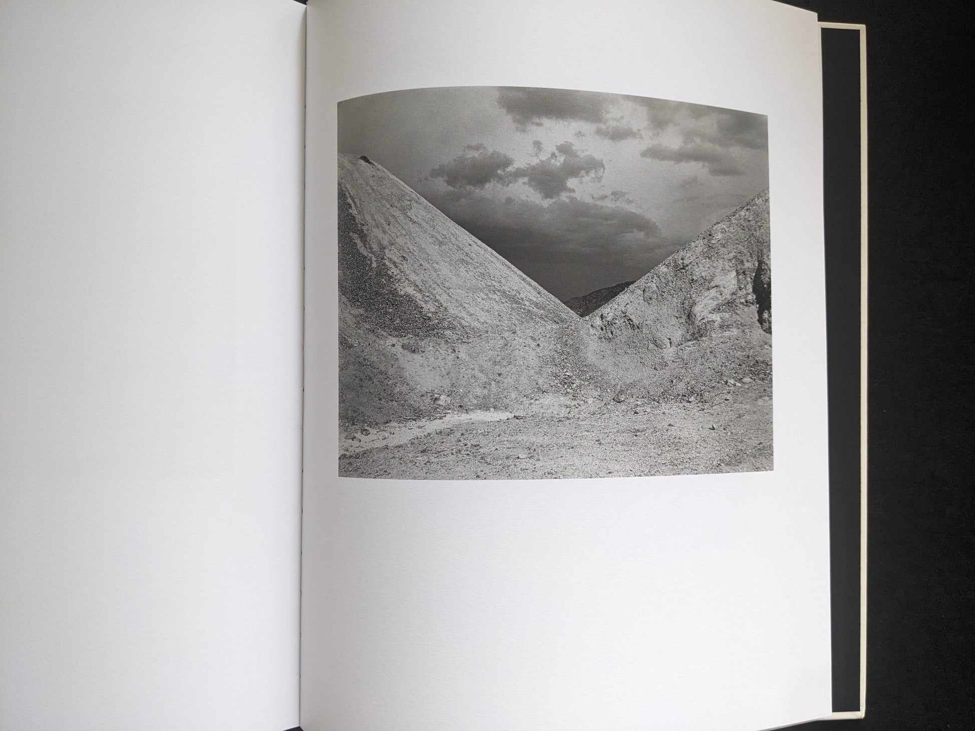 Interior photograph from Mimi Plumb’s Landfall showing a rocky slope and open sky in a stark landscape.
