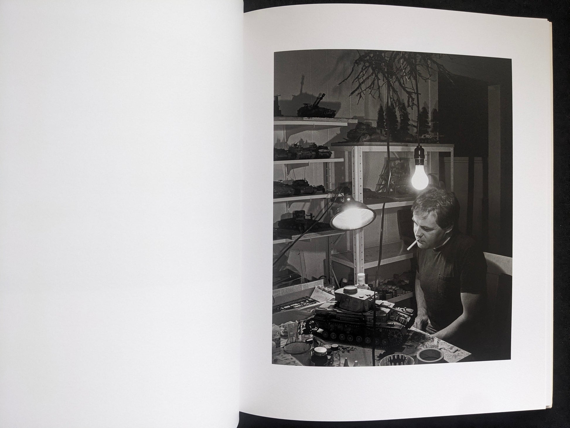 Interior photograph from Mimi Plumb’s Landfall showing a person at a workbench under a desk lamp.