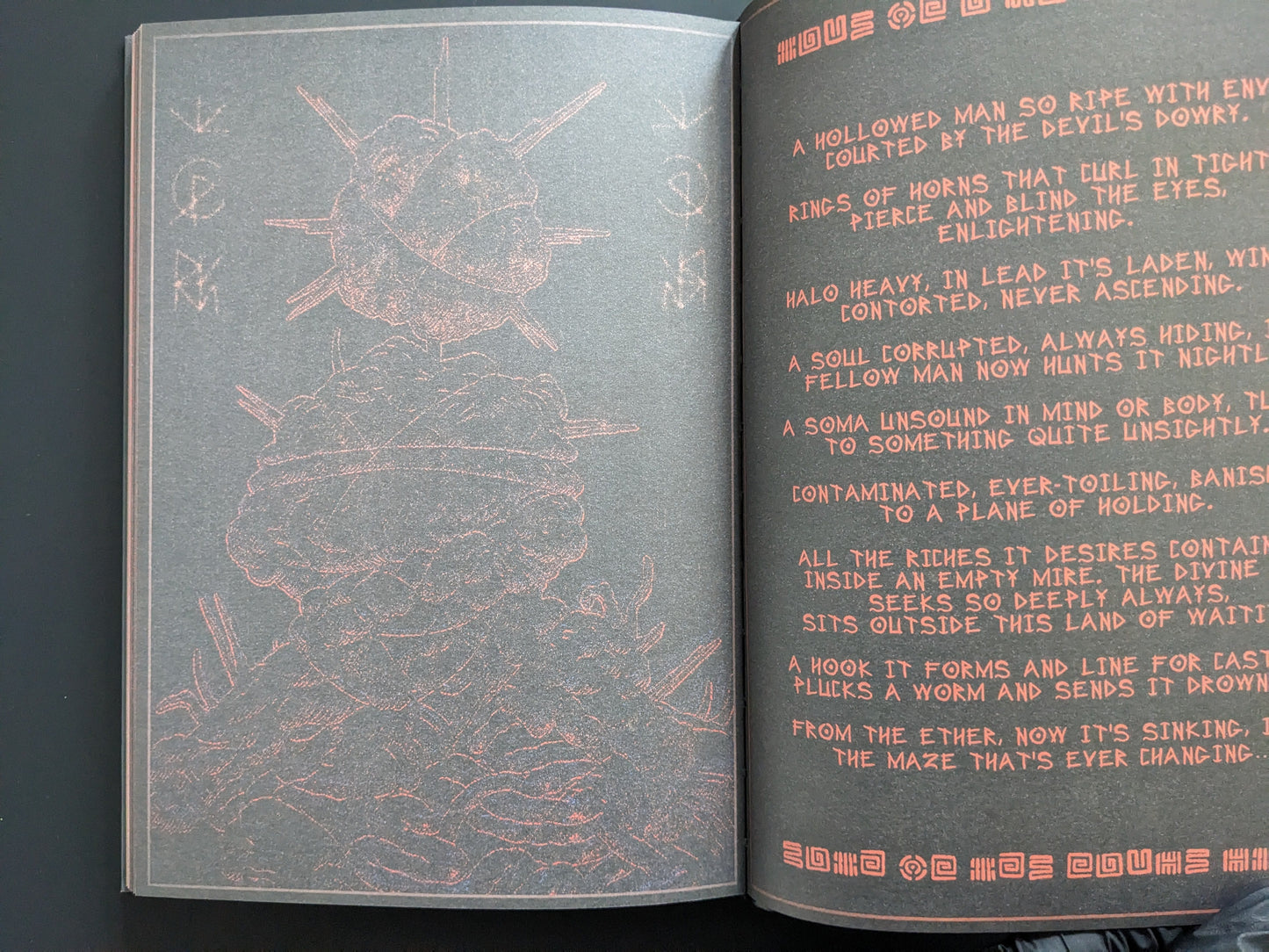 Interior page with red printed text and a surreal illustration of spiked organic forms.