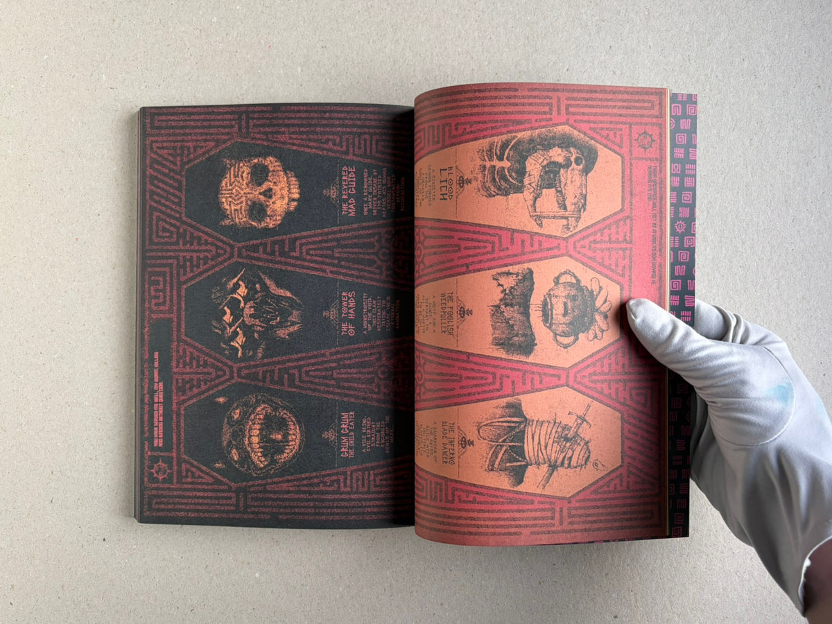 Open spread of the book held flat, with dense illustrated pages and a gloved hand at the right edge.