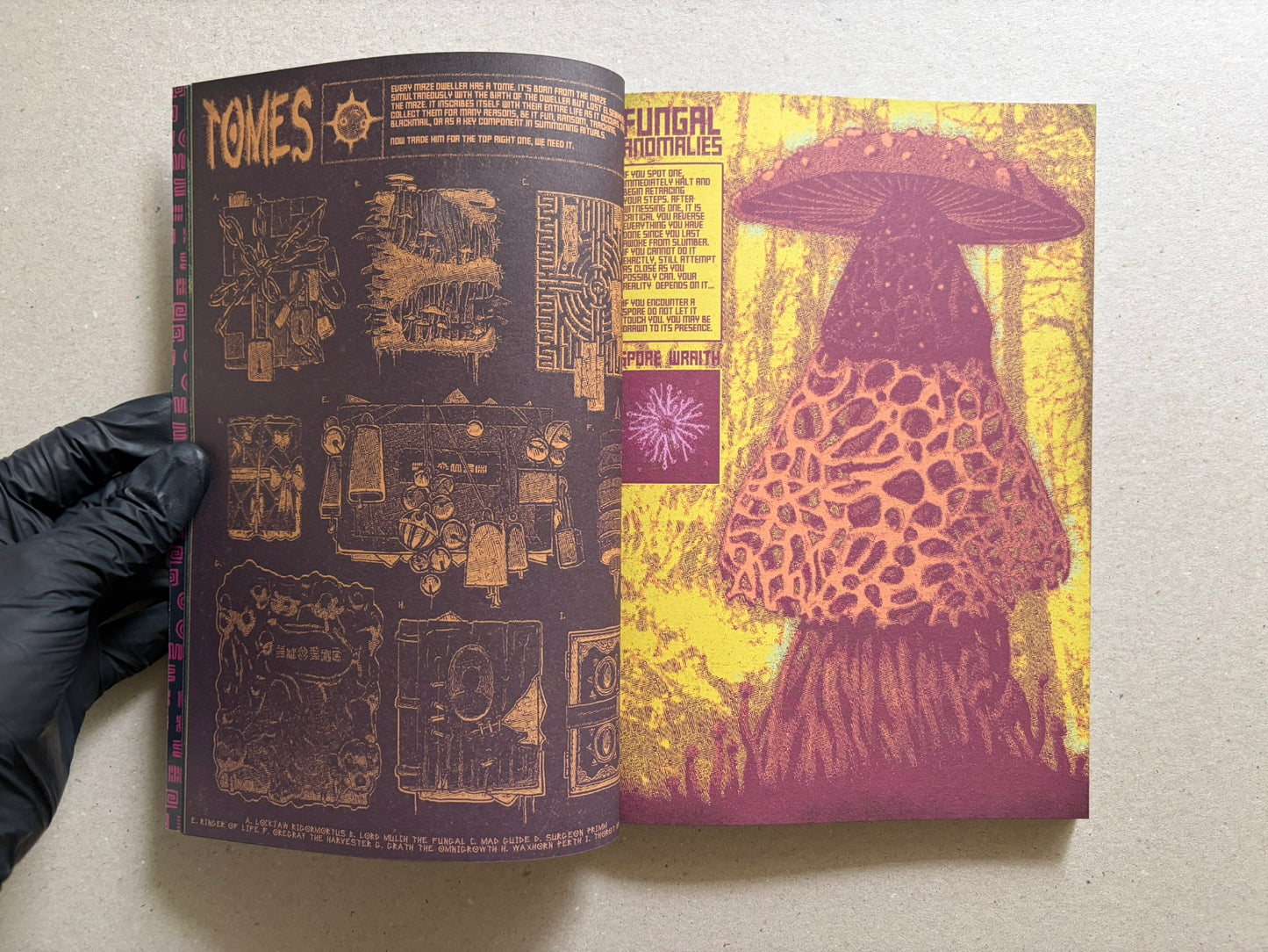 Interior spread of Mock Soul "maze devil pilgrimage" with a dark left page of diagrams and a bright yellow-and-magenta illustrated right page.