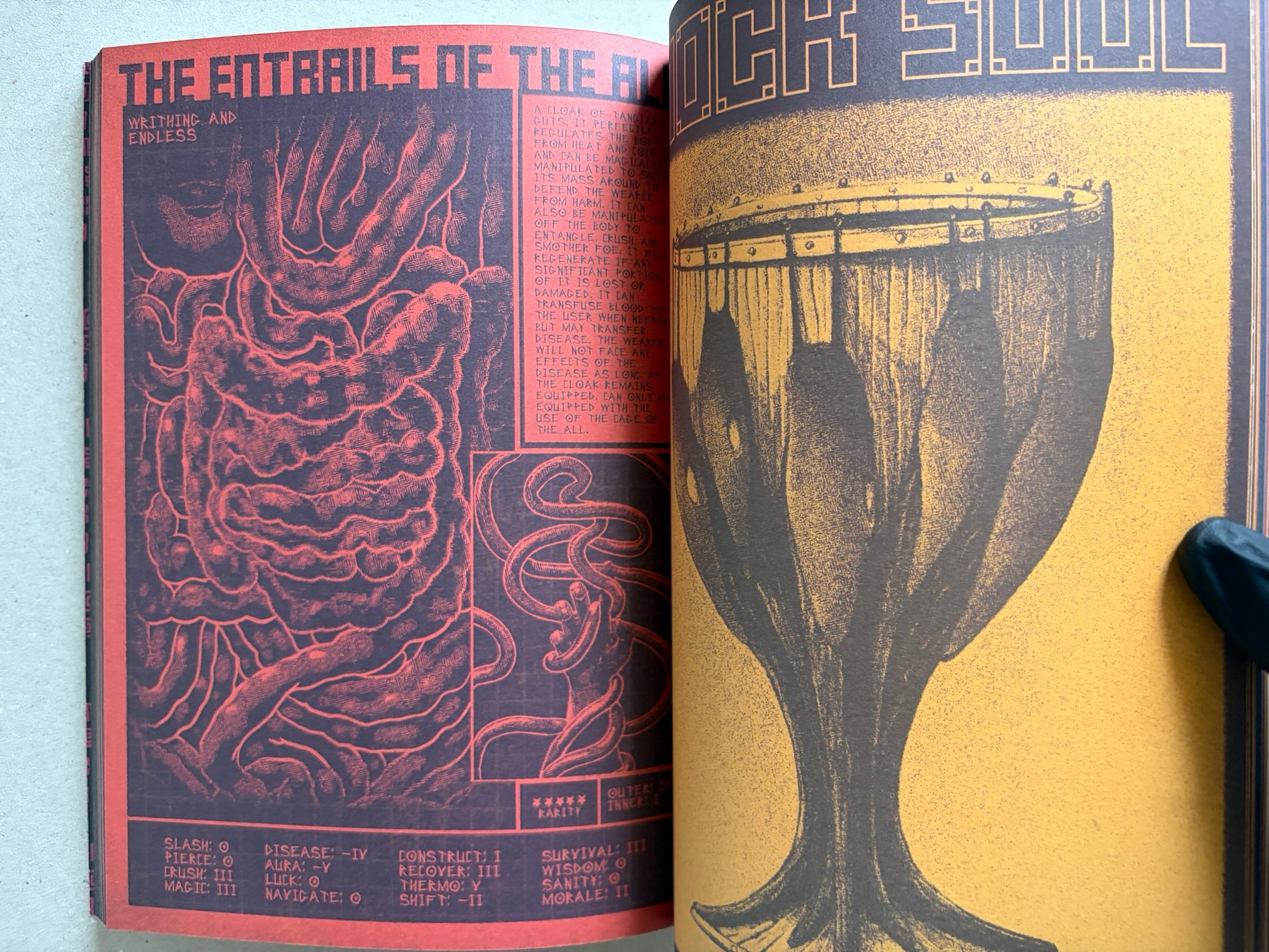 Interior spread of Mock Soul "maze devil pilgrimage" with orange-and-black hand and sword illustrations and a large blade on the right page.