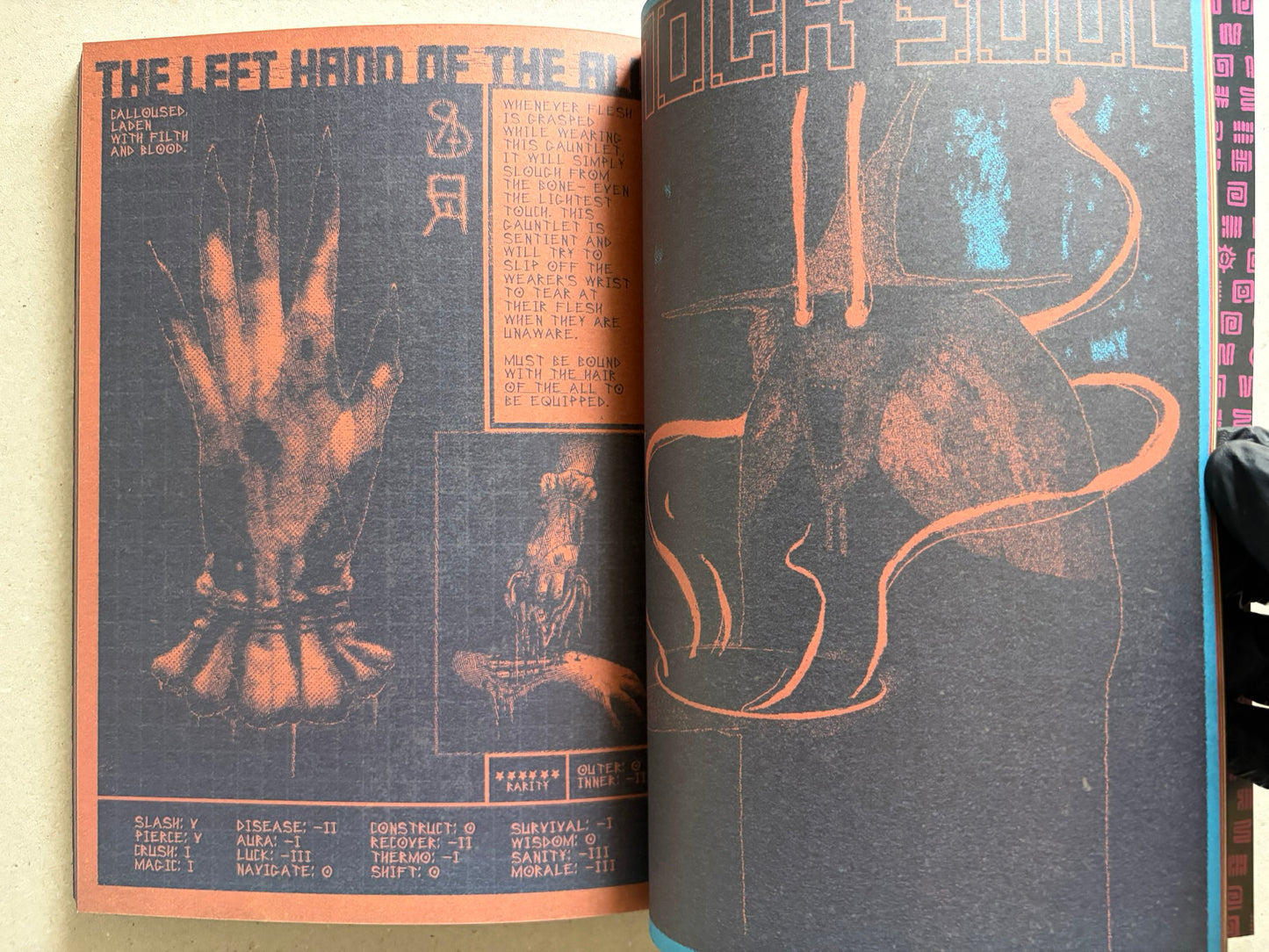 Interior spread of Mock Soul "maze devil pilgrimage" with orange-and-black hand studies on the left page and a large vessel or blade form on the right page.