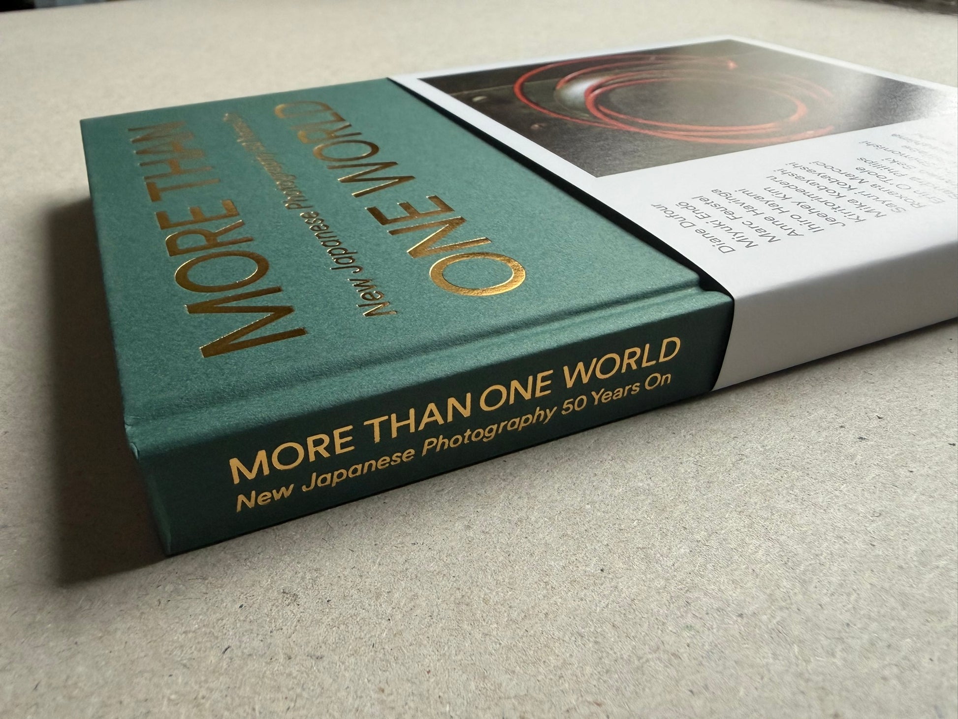 More Than One World – New Japanese Photography 50 Years On in its slipcase, shown from a low angle with the cover partly visible.