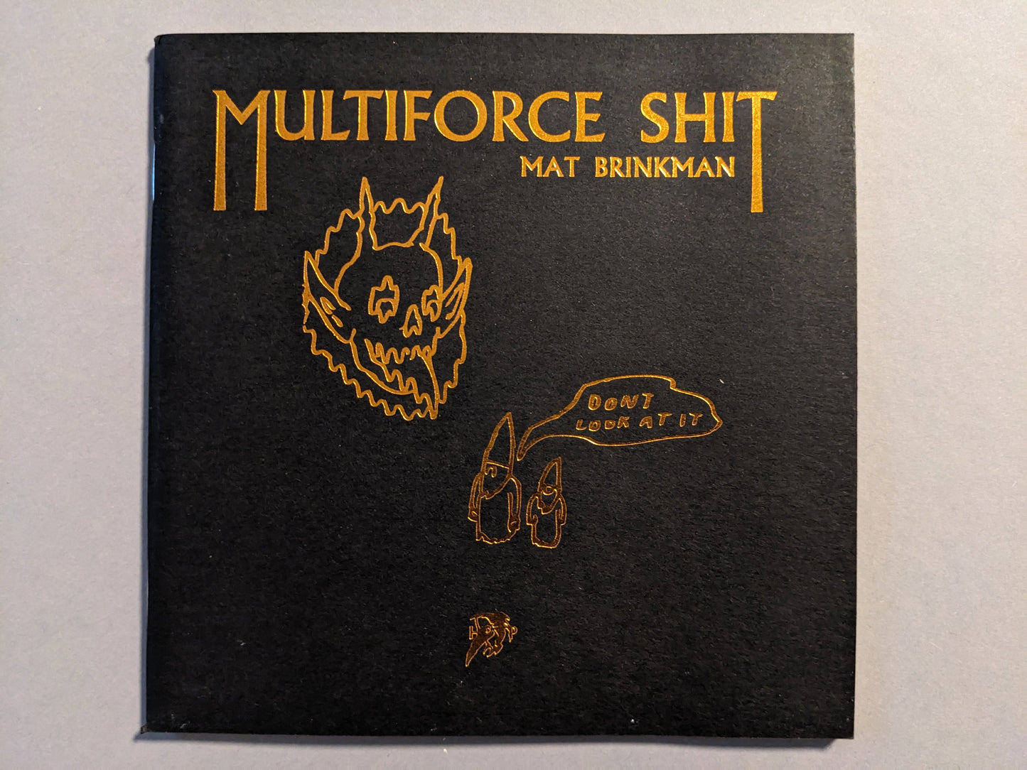 Cover of "Multiforce Shit" by Mat Brinkman, Hollow Press, limited edition art zine, black paper with bronze ink