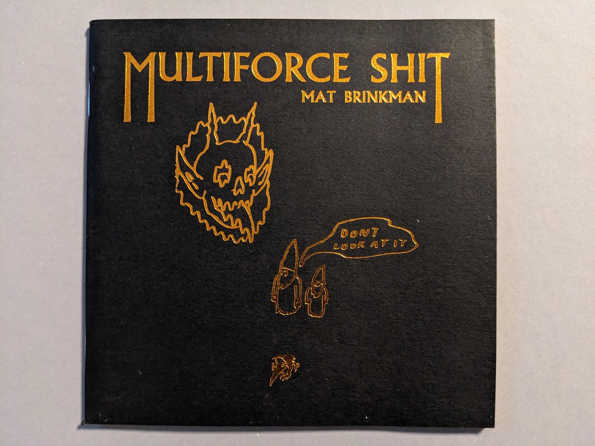 Cover of "Multiforce Shit" by Mat Brinkman, Hollow Press, limited edition art zine, black paper with bronze ink
