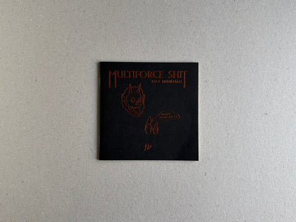Front cover of Multiforce Shit by Mat Brinkman, shown as a black square booklet with red lettering and line drawings.