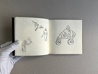 Open sketchbook spread from Multiforce Shit by Mat Brinkman, showing small black line drawings on the left page and a larger abstract figure on the right page.