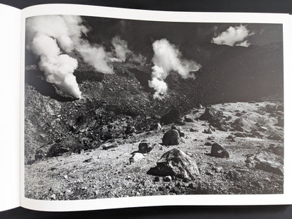 Black and white image of steaming vents in rocky terrain, New Land
