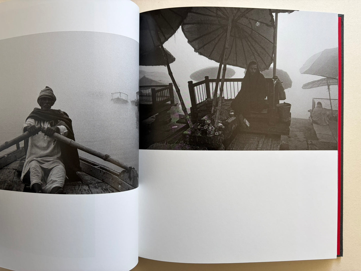 Interior spread from Naked City Varanasi showing a boatman in fog and a seated woman beneath umbrellas by the river.