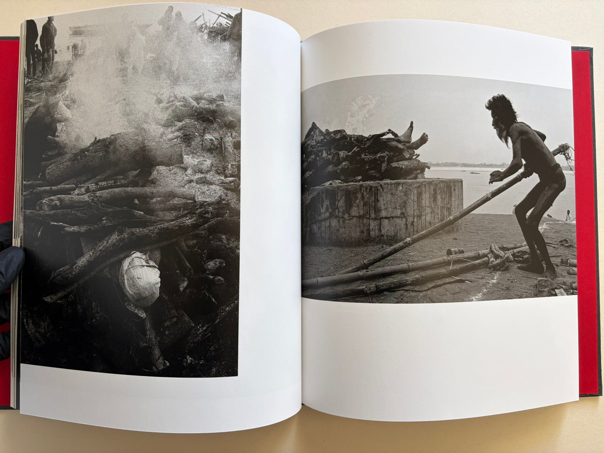 Interior spread from Naked City Varanasi showing a cremation scene and a worker handling wood beside a funeral pyre.