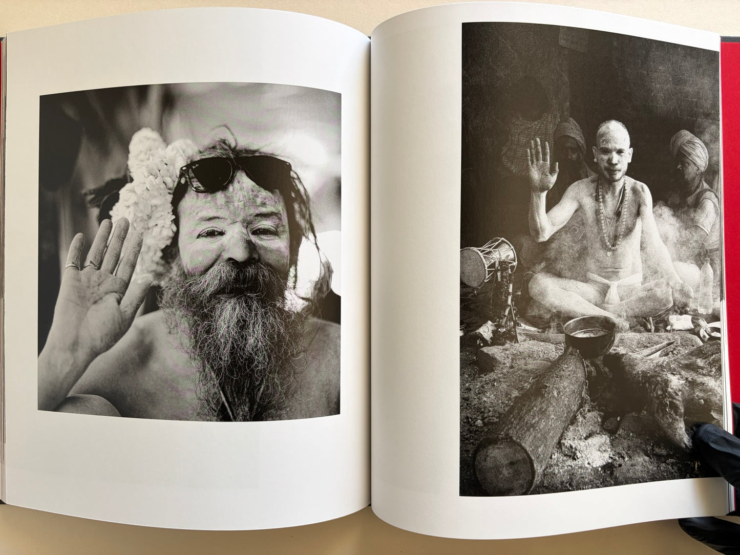 Interior spread from Naked City Varanasi showing two black-and-white portraits of men raising a hand toward the camera.