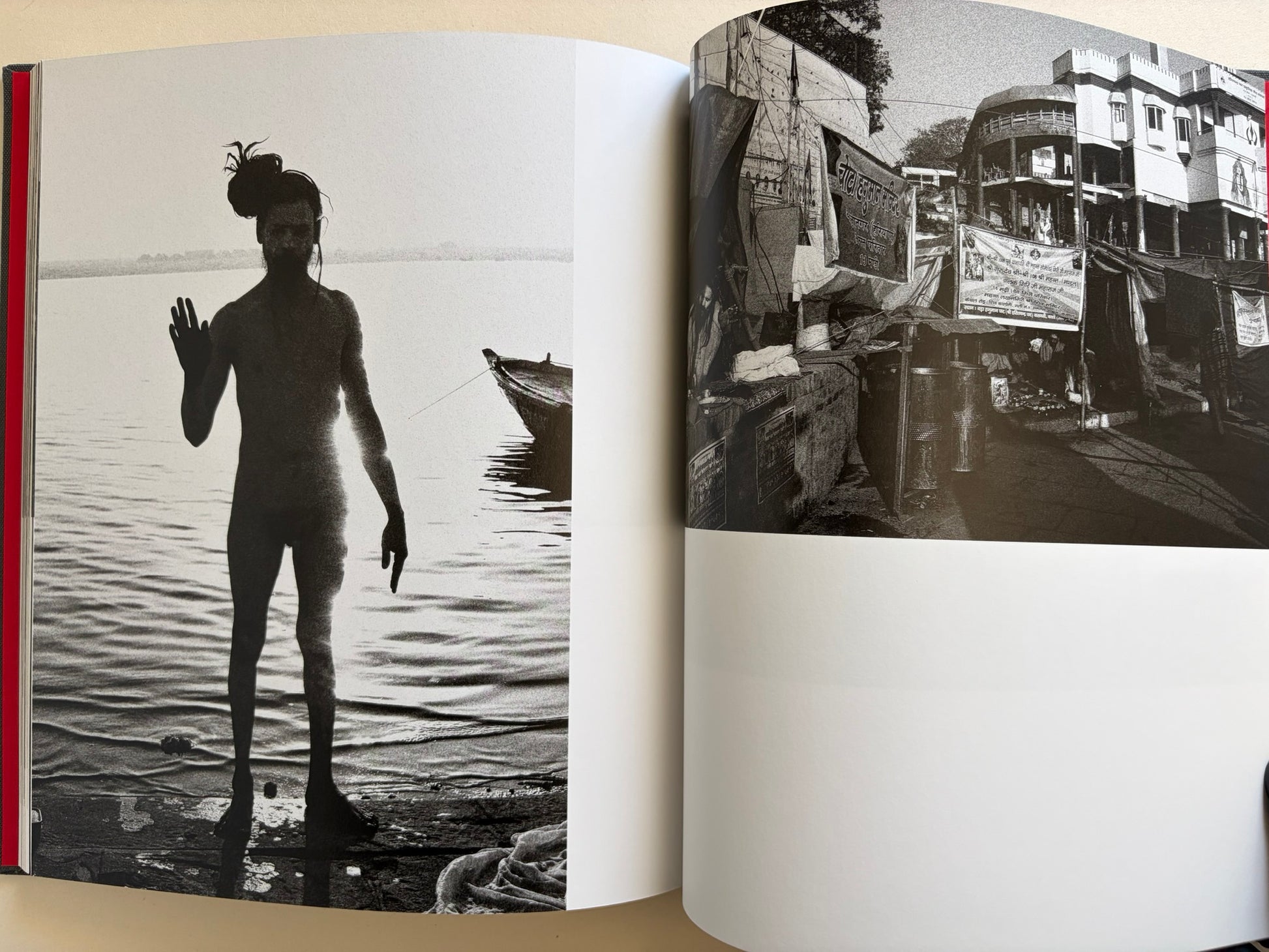 Interior spread from Naked City Varanasi showing a silhouetted figure in the river and a dark street scene near the ghats.