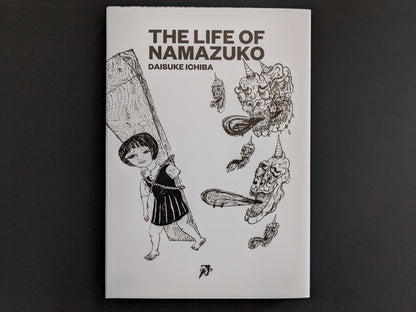 Front cover of The Life of Namazuko by Daisuke Ichiba, showing a girl carrying a plank surrounded by surreal demon heads.