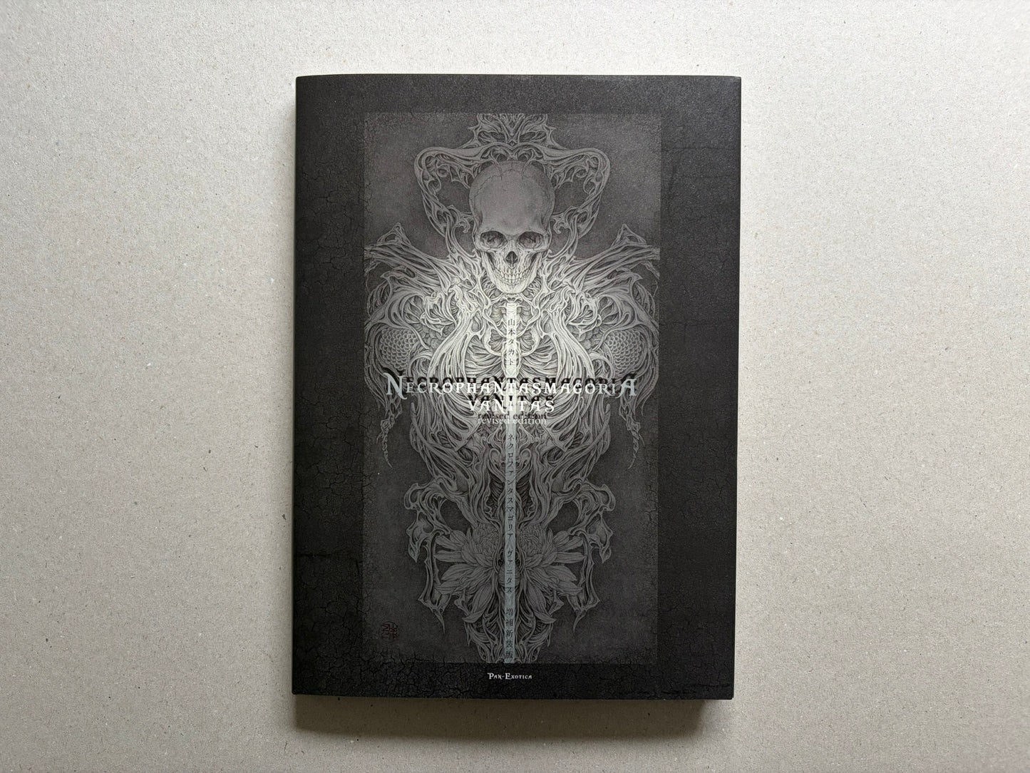 Necrophantasmagoria Vanitas by Takato Yamamoto, front cover with skull and ornamental figure on a black background.